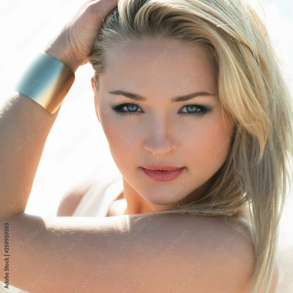 Fototapeta premium young beautiful woman blonde poses on a beach