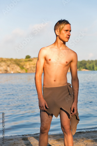 guy in loincloth on the background of river beach