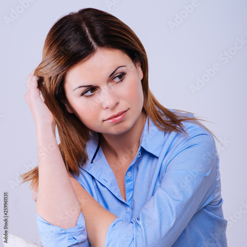 woman in blue shirt sitting on the chair