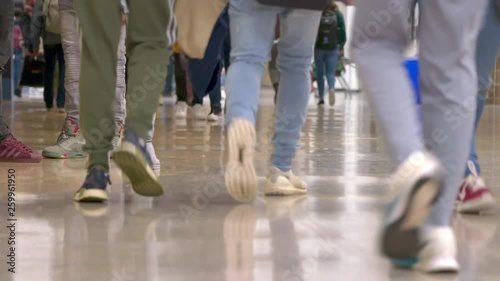 Ground level shot of multi-ethnic teenage high school students standing and walking in the hall of their school. ProRes file, shot in 4K UHD. photo