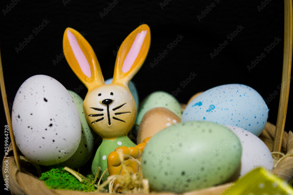 Easter bunny relaxing with easter eggs and moss grass Easter bunny relaxing with easter eggs and moss grass