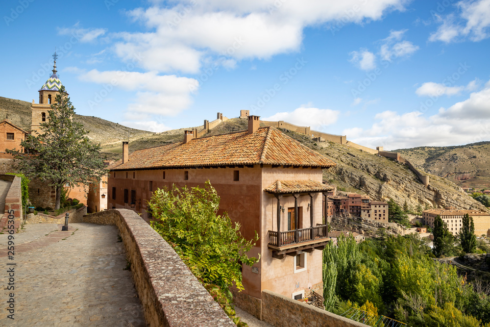 a street and a view of the medieval wall in Albarracin town, province of Teruel, Aragon, Spain