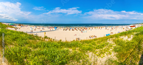 Fototapeta Naklejka Na Ścianę i Meble -  Swinoujscie, Poland - July 7, 2014: Panoramic view of crowded Baltic sea beach on Usedom island in Swinoujscie city, Poland