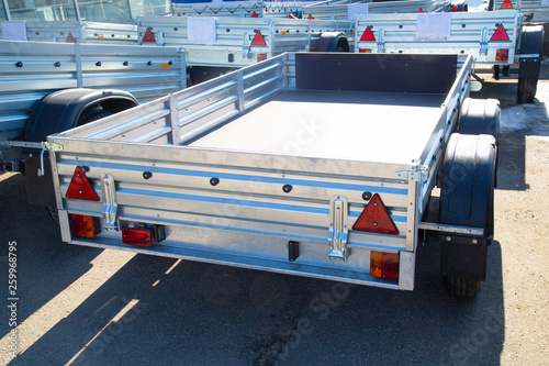 Open car trailer,ow; cargo; car trailer; trailer truck; tow bar. photo