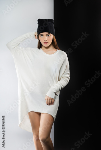 Young beautiful girl posing in Studio on black and white background