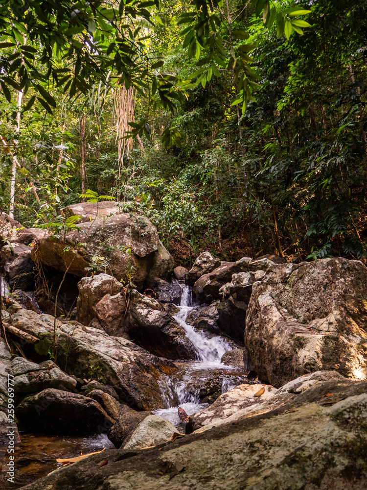 Water flows over the rocks of the waterfall on Koh Phangan. Thailand Water flows over the rocks of the waterfall on Koh Phangan. Thailand