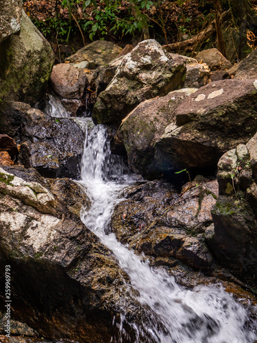 Water flows over the rocks of the waterfall on Koh Phangan. Thailand