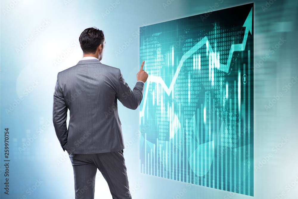 Businessman in futuristic stock trading concept Businessman in futuristic stock trading concept