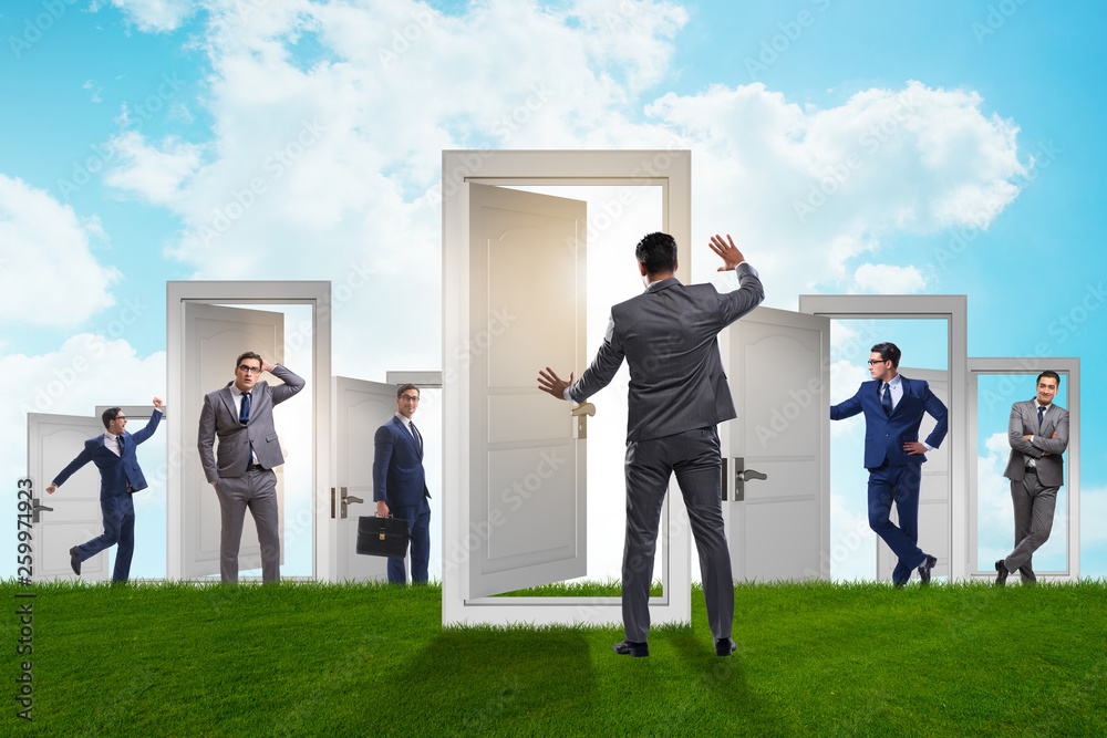 Fototapeta premium Businessman in uncertainty concept with many doors