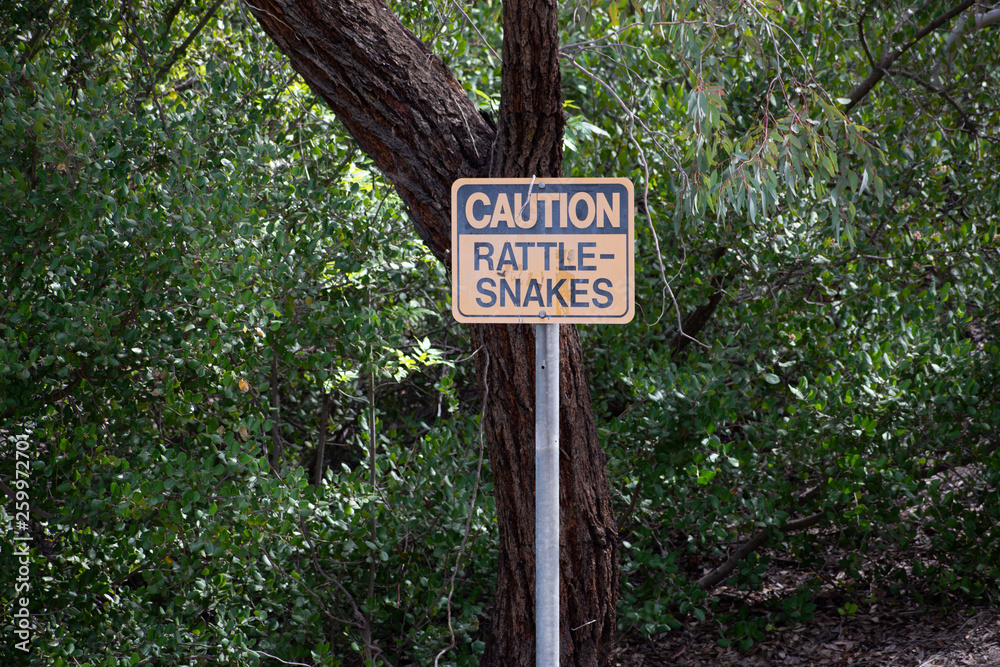 Rattlesnake warning/caution sign at park in West Hills, Los Angeles, California Rattlesnake warning/caution sign at park in West Hills, Los Angeles, California