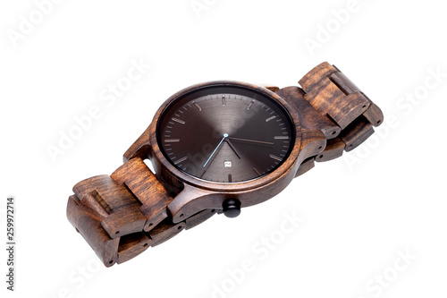 Wooden wrist watches lie side view on a white background.