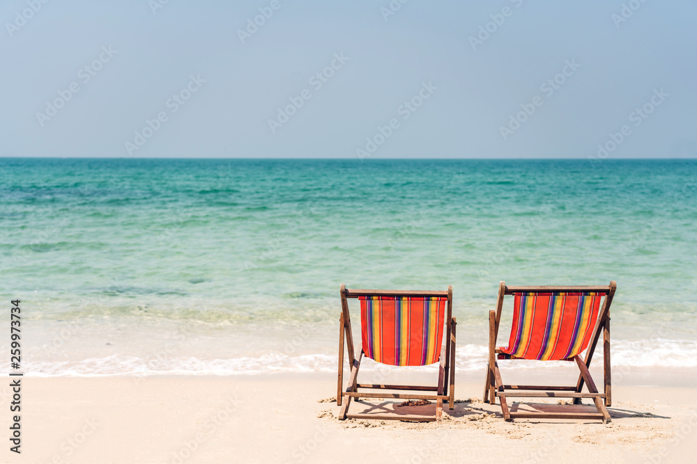 Two chairs on the beach near sea.Summer and vacation concept background Two chairs on the beach near sea.Summer and vacation concept background