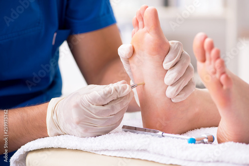 Foto Podiatrist treating feet during procedure