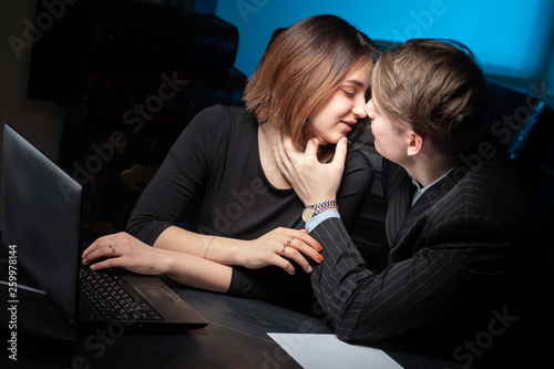 Kissing lovers in the workp...