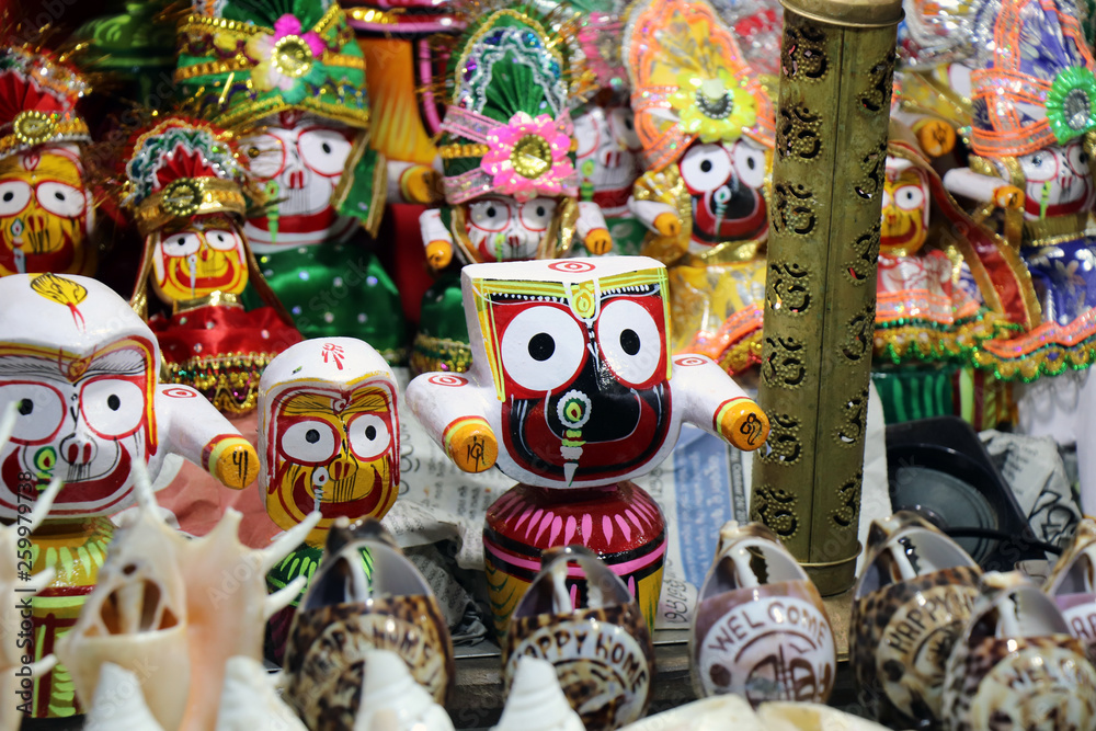 Statues of Lord Jagannath on the street market in Puri. On the Puri beach, Odisha, these awesome statues were kept to sell. Close up and details of traditional artisan objects, Asian culture concept.