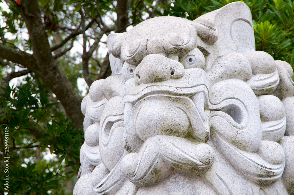 Huge Komainu (dog-lion like guardian) stone statue Izanagi Shrine on Awaji Island in Japan