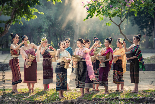 Fotografie Vientiane Laos APRIL 4 2019 : Young happy beauty Asian woman splashing water during  Water Songkran festival ,Thailand Laos traditional