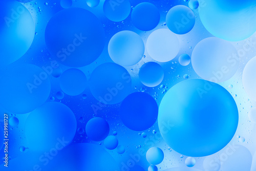 water drops on glass with blue background  close-up 