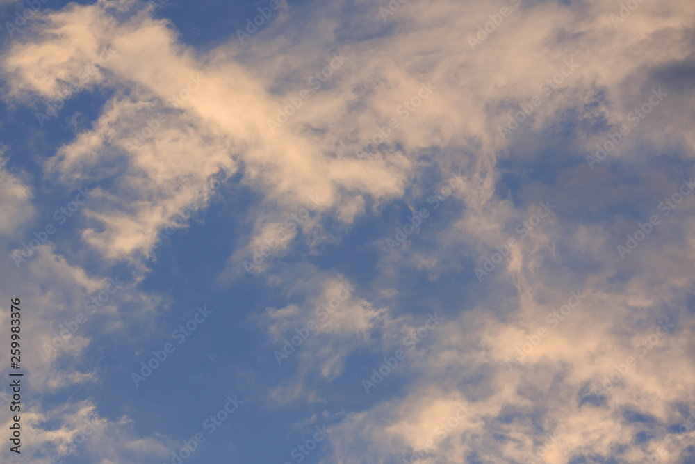 beautiful clear blue sky with golden sunshine on fluffy cloud