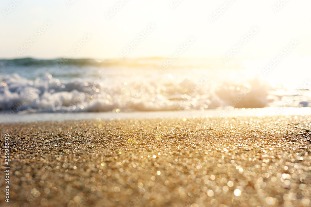 background image of sandy beach and ocean waves with bright bokeh lights background image of sandy beach and ocean waves with bright bokeh lights