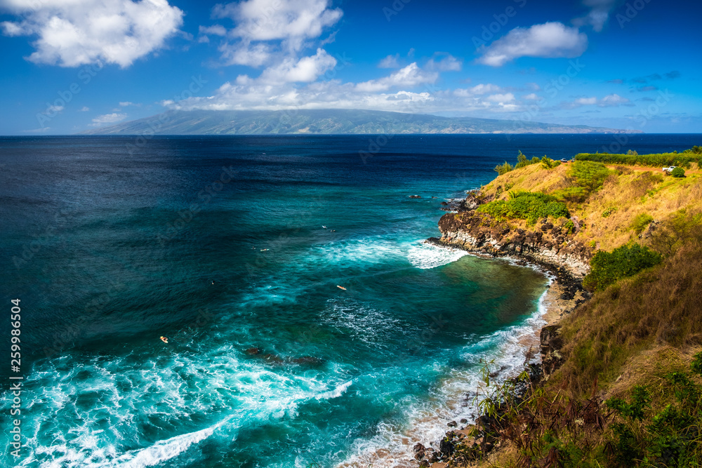 Honolua Bay with waves and surfers in the water. Maui, Hawaii