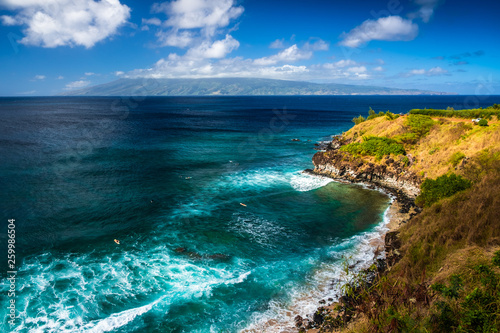 Honolua Bay with waves and surfers in the water. Maui, Hawaii