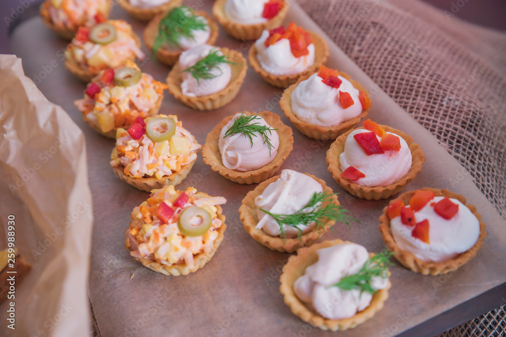 Tasty and juicy snacks for buffet table: mini burgers, canapés, fruit, sliced and baked Tasty and juicy snacks for buffet table: mini burgers, canapés, fruit, sliced and baked