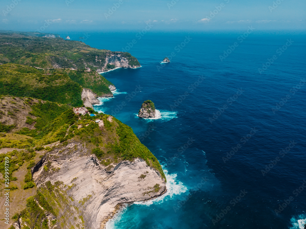 Coastline with cliff and ocean in Nusa Penida. Aerial view of tropical island Coastline with cliff and ocean in Nusa Penida. Aerial view of tropical island