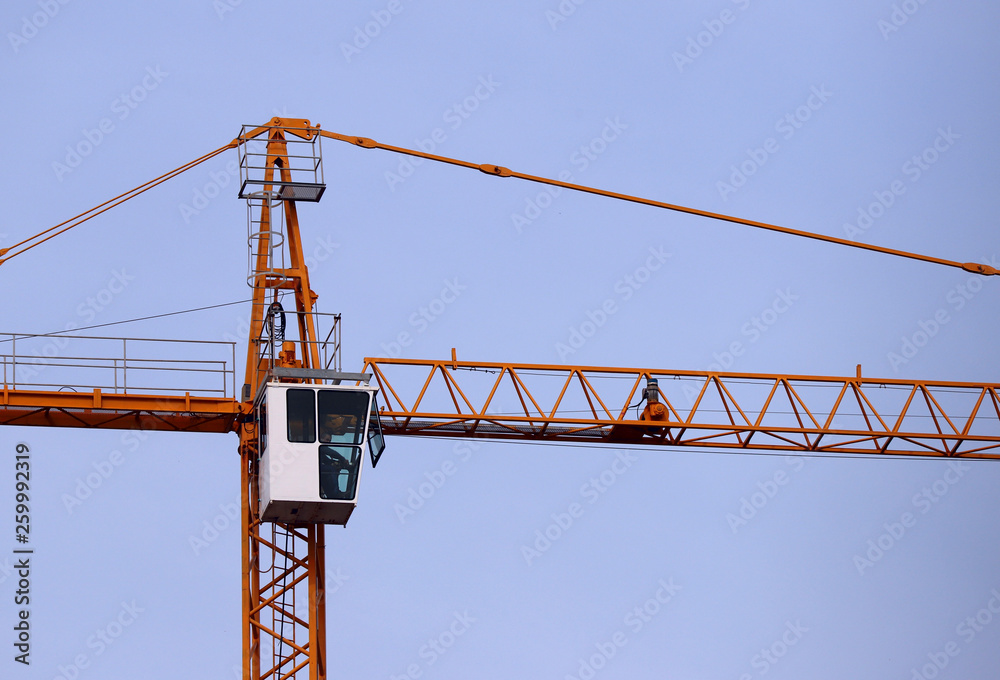 Fragment of a construction crane against the sky. Cropped shot, horizontal, a lot of free space for text. Concept of construction and technology. Fragment of a construction crane against the sky. Cropped shot, horizontal, a lot of free space for text. Concept of construction and technology.