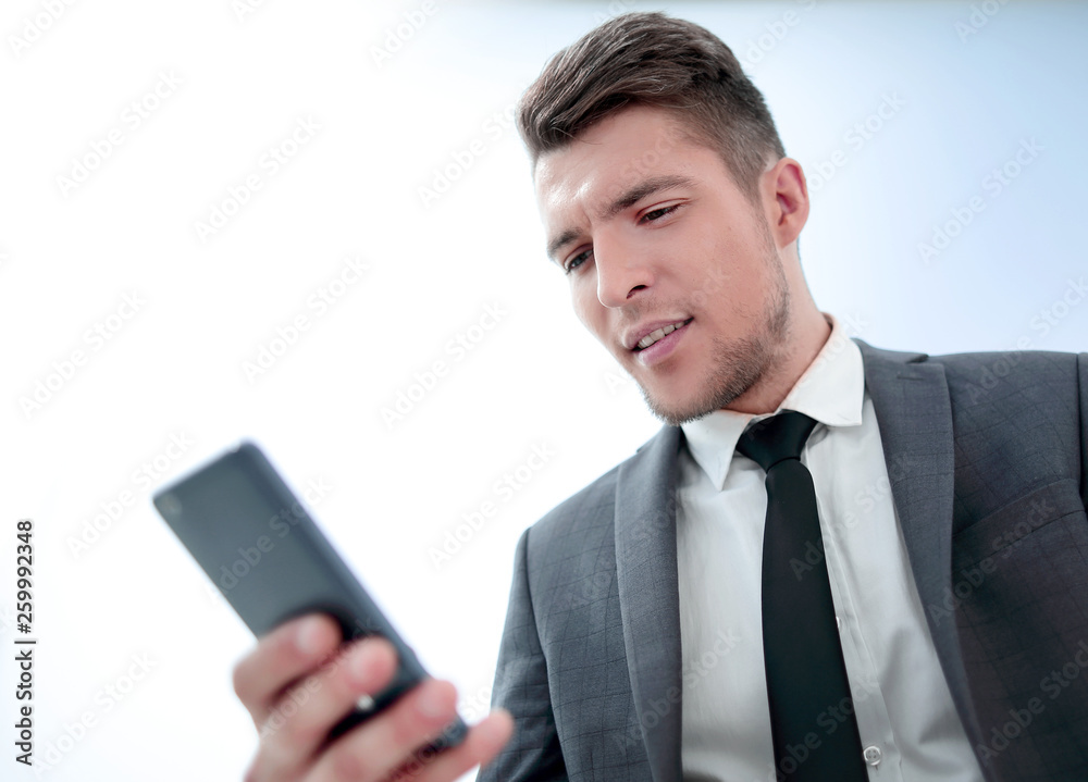 serious businessman with phone reading message serious businessman with phone reading message