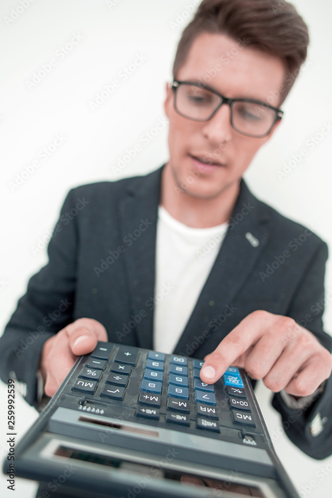 close up.smiling businessman counting profits on calculator. close up.smiling businessman counting profits on calculator.