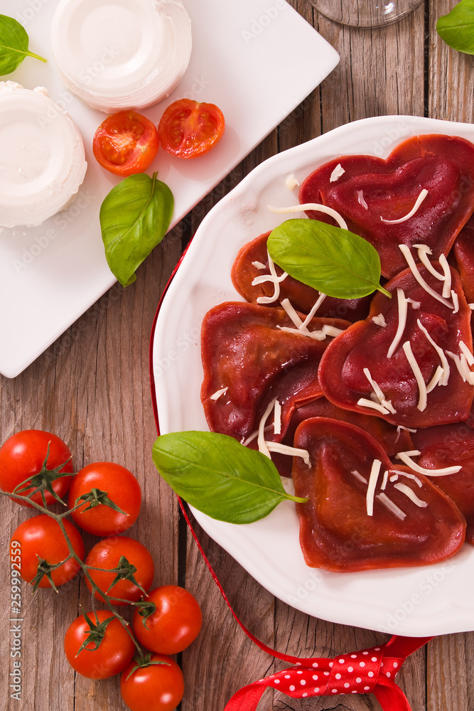 Red heart ravioli with tomato, mozzarella and basil. Red heart ravioli with tomato, mozzarella and basil.