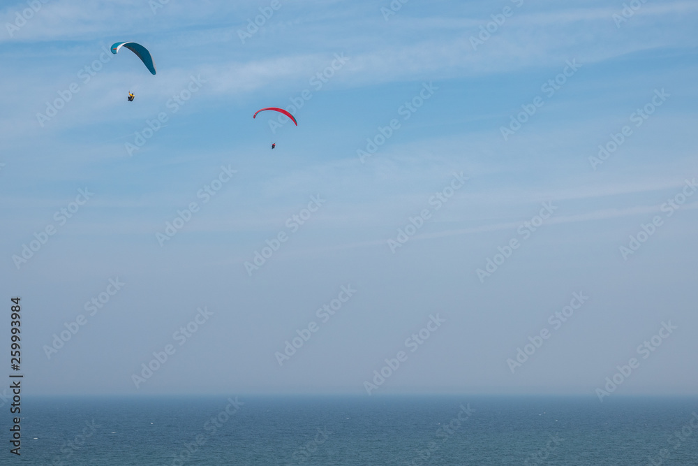 some paragliders fly along the steep coast of the Baltic Sea some paragliders fly along the steep coast of the Baltic Sea