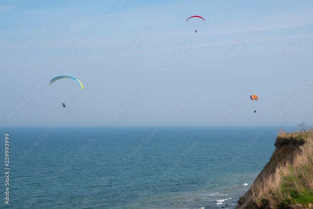 some paragliders fly along the steep coast of the Baltic Sea some paragliders fly along the steep coast of the Baltic Sea