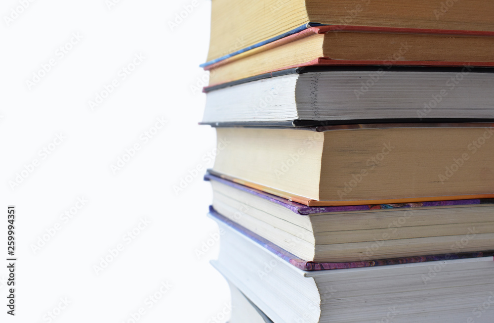 Stack of multicolored books. Old textbooks stacked on each other. Online education training skill courses concept on white background and nobody Stack of multicolored books. Old textbooks stacked on each other. Online education training skill courses concept on white background and nobody