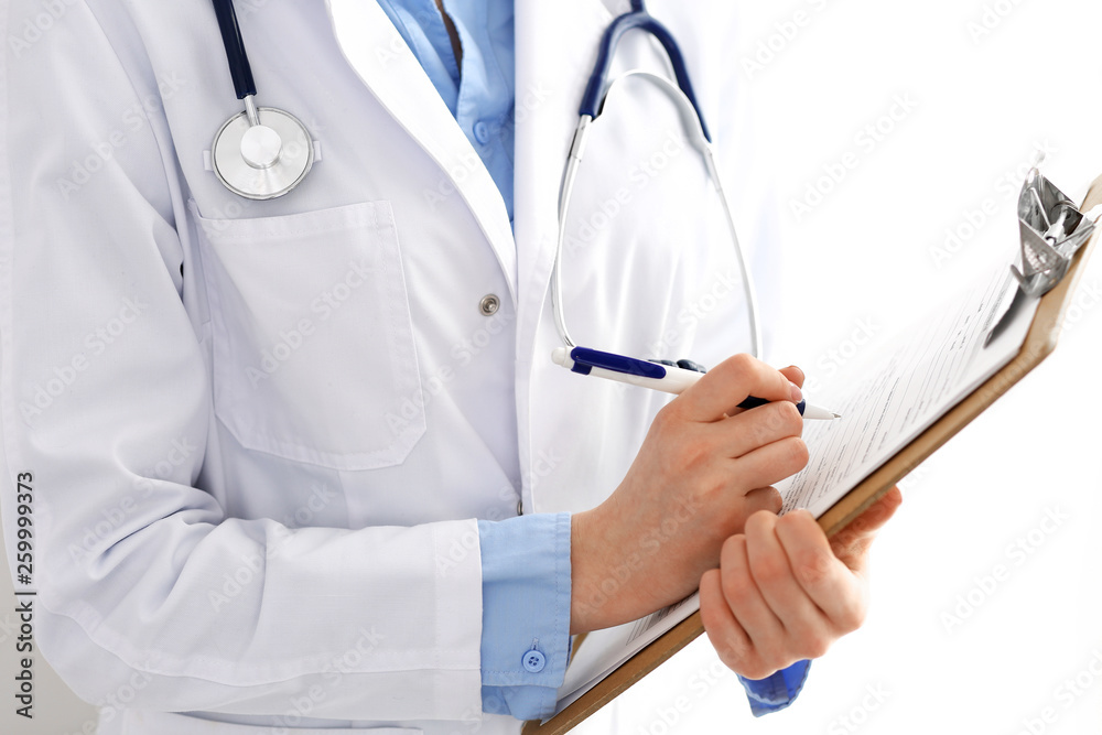 Female doctor using medical form on clipboard closeup. Physicianat work in hospital or clinic. Healthcare, insurance and medicine concept Female doctor using medical form on clipboard closeup. Physicianat work in hospital or clinic. Healthcare, insurance and medicine concept