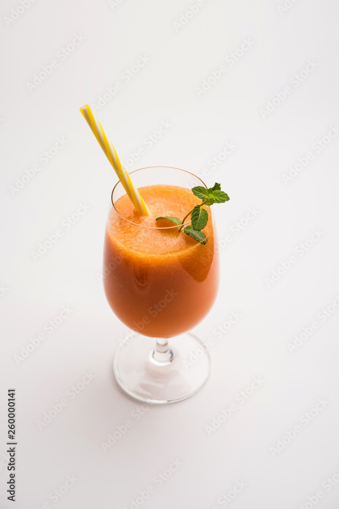 Musk melon juice with slice, also known as Kharbuj/kharbuja fruit extract, served in a glass with mint. selective focus Musk melon juice with slice, also known as Kharbuj/kharbuja fruit extract, served in a glass with mint. selective focus