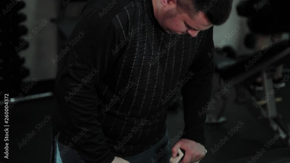 Cheerful fat man performs a wrong exercise in the gym. For the first time in a fitness club. Cheerful fat man performs a wrong exercise in the gym. For the first time in a fitness club.