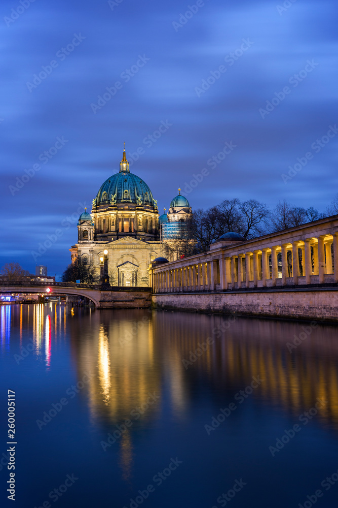 Fototapeta premium Beautiful view of illuminated Berliner Dom (Berlin Cathedral) on Museum Island and reflections on the Spree River in Berlin, Germany, at dusk. Copy space.