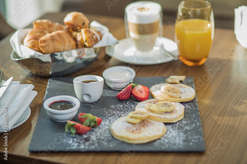 pancakes with cottage cheese for breakfast in a cafe, restaurant. Pancakes with cheese and strawberries, and mint