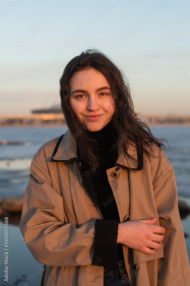 Portrait of the beautiful girl. Photo shoot near river at winter.