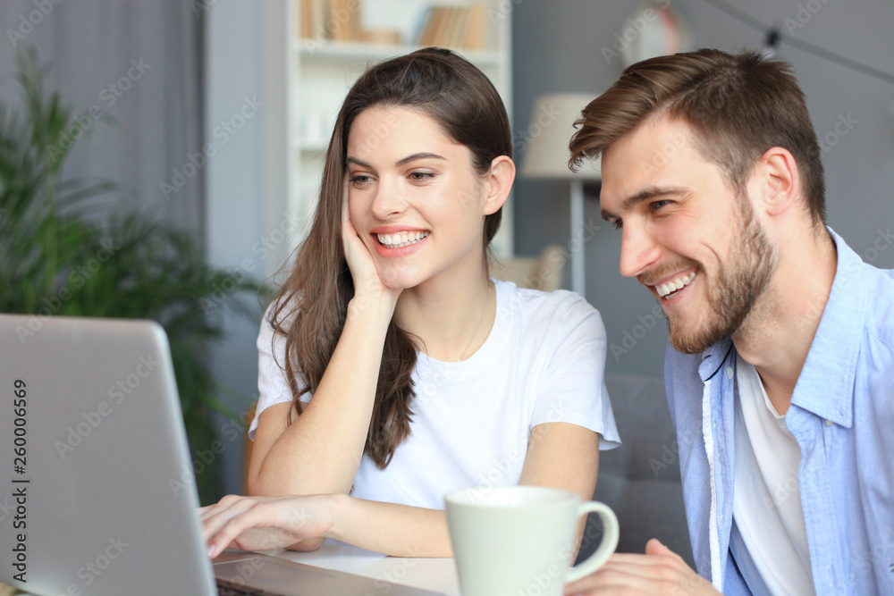 Couple pointing while working together on laptop. Couple pointing while working together on laptop.