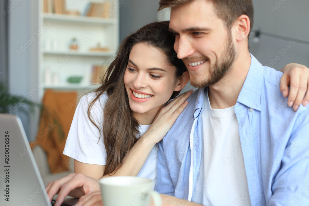 Couple pointing while working together on laptop. Couple pointing while working together on laptop.