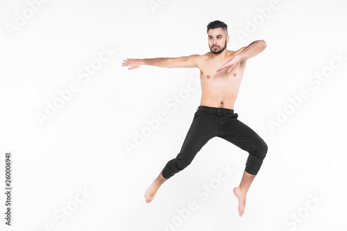 Full length of man ballet dancer leaping in mid air isolated on white background.