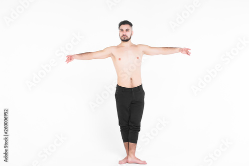 Handsome young ballet dancer on white background.