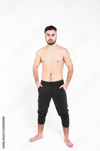 Bodybuilder posing. Handsome power athletic guy male. Young muscular man with hands on his pants,isolated on white.