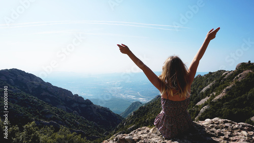 Young happy woman enjoying the magnifisent view of Montserrat Mountains photo