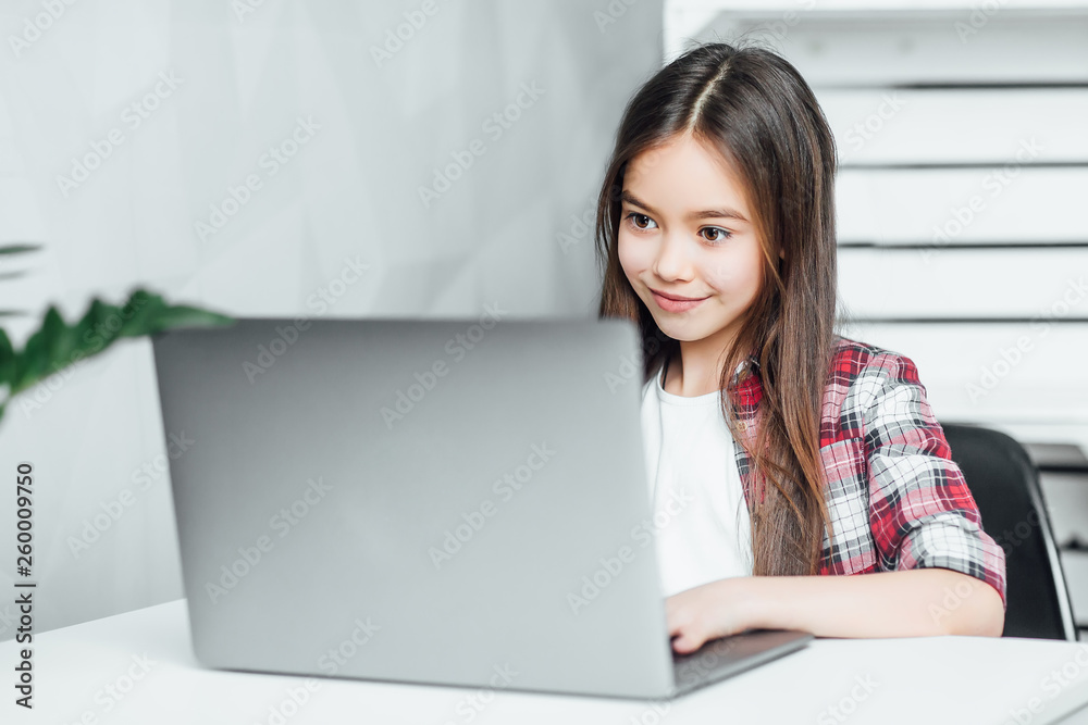 Great day. Attractive inspired dark-eyed dark-haired girl while sitting at notebook the table at home! Great day. Attractive inspired dark-eyed dark-haired girl while sitting at notebook the table at home!