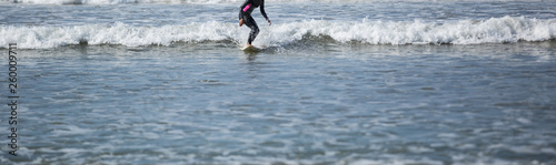 Surfer woman practice surfing in the white water