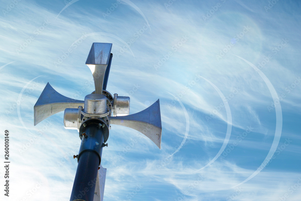 Outdoor loudspeaker against the background of blue sky, sound waves. Outdoor loudspeaker against the background of blue sky, sound waves.